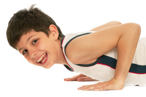 A sporty boy is pushing up; isolated on the white background